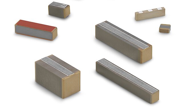 Various monolithic multilayer actuators from CeramTec on a white background