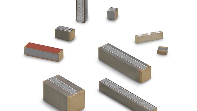 Various monolithic multilayer actuators from CeramTec on a white background